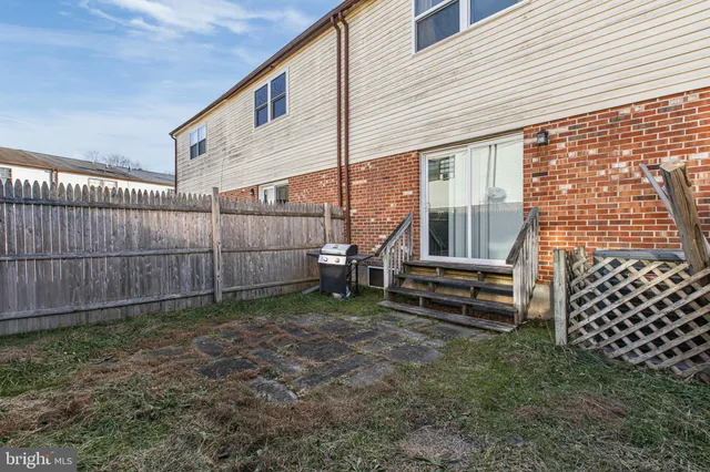 a view of a house with a wooden fence