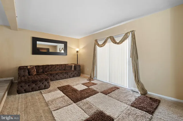 a living room with furniture and a rug