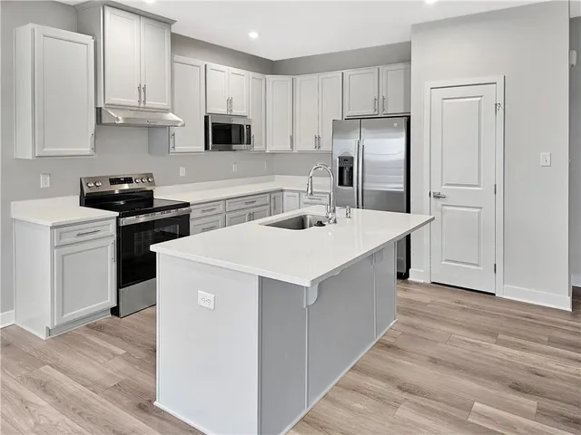 a kitchen with a sink a stove and refrigerator