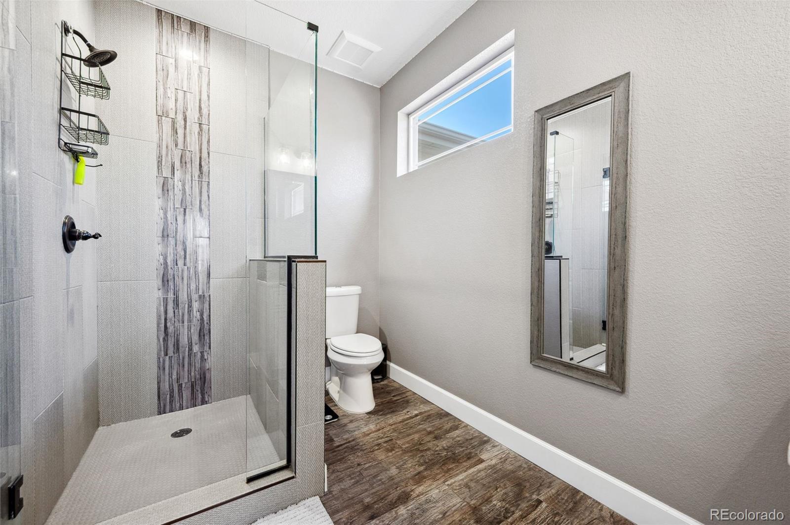 156 Chapel Hill Circle Brighton, CO 80601 - Photo 12 of 48 a bathroom with a shower and a toilet