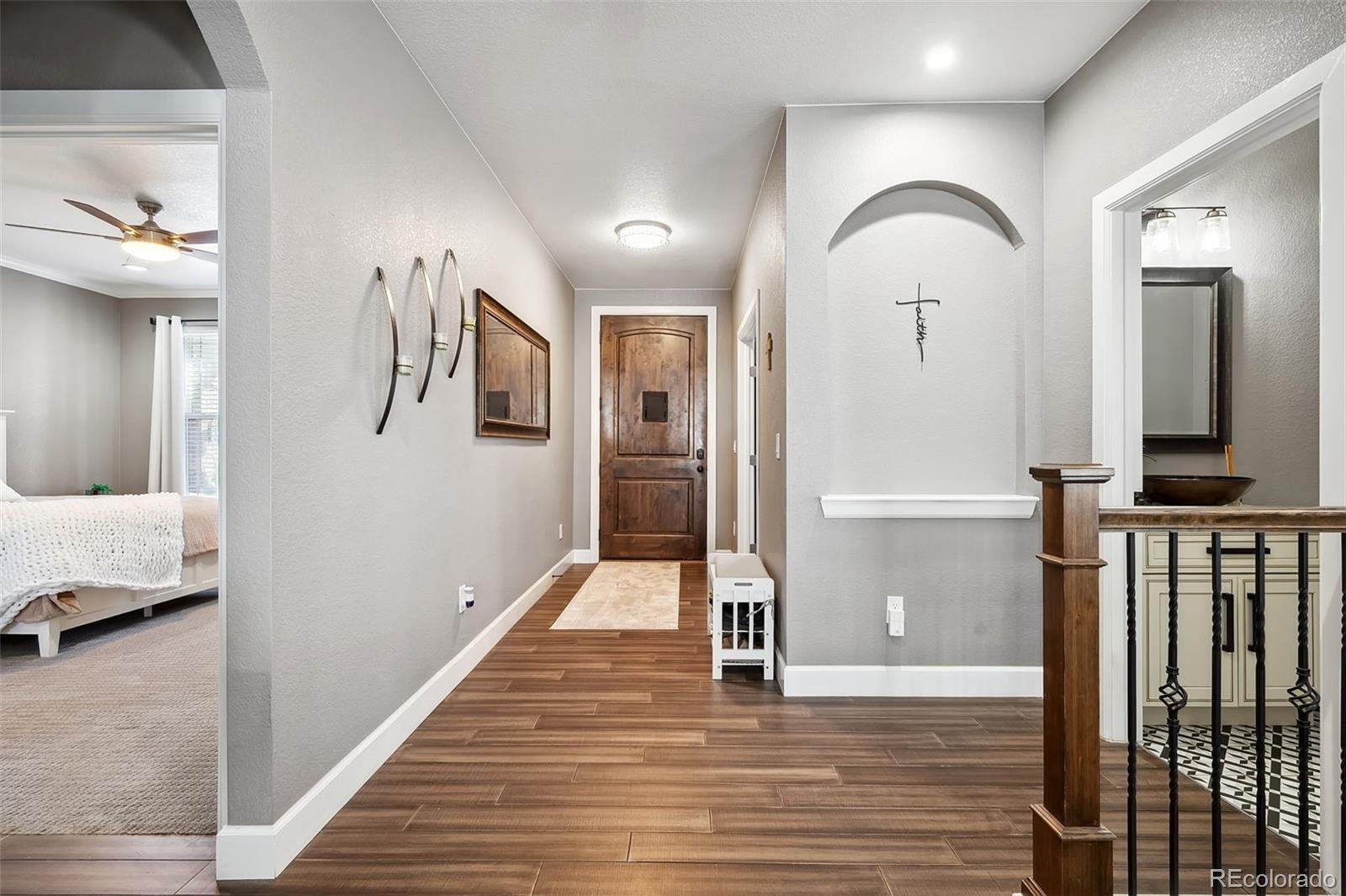 156 Chapel Hill Circle Brighton, CO 80601 - Photo 13 of 48 a view of a hallway with wooden floor and staircase