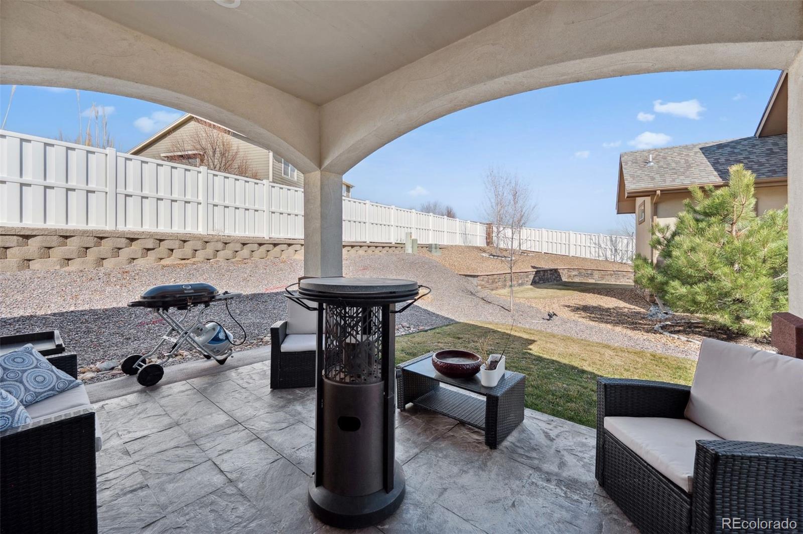 156 Chapel Hill Circle Brighton, CO 80601 - Photo 15 of 48 a living room with furniture a rug and a potted plant