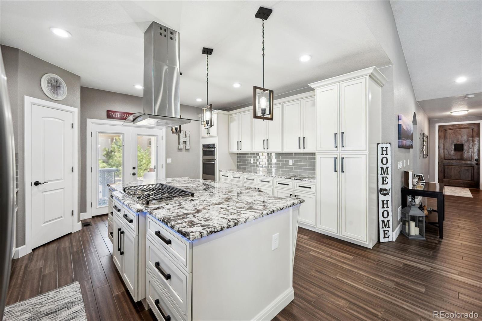 156 Chapel Hill Circle Brighton, CO 80601 - Photo 18 of 48 a kitchen with stainless steel appliances granite countertop a stove refrigerator and wooden floor