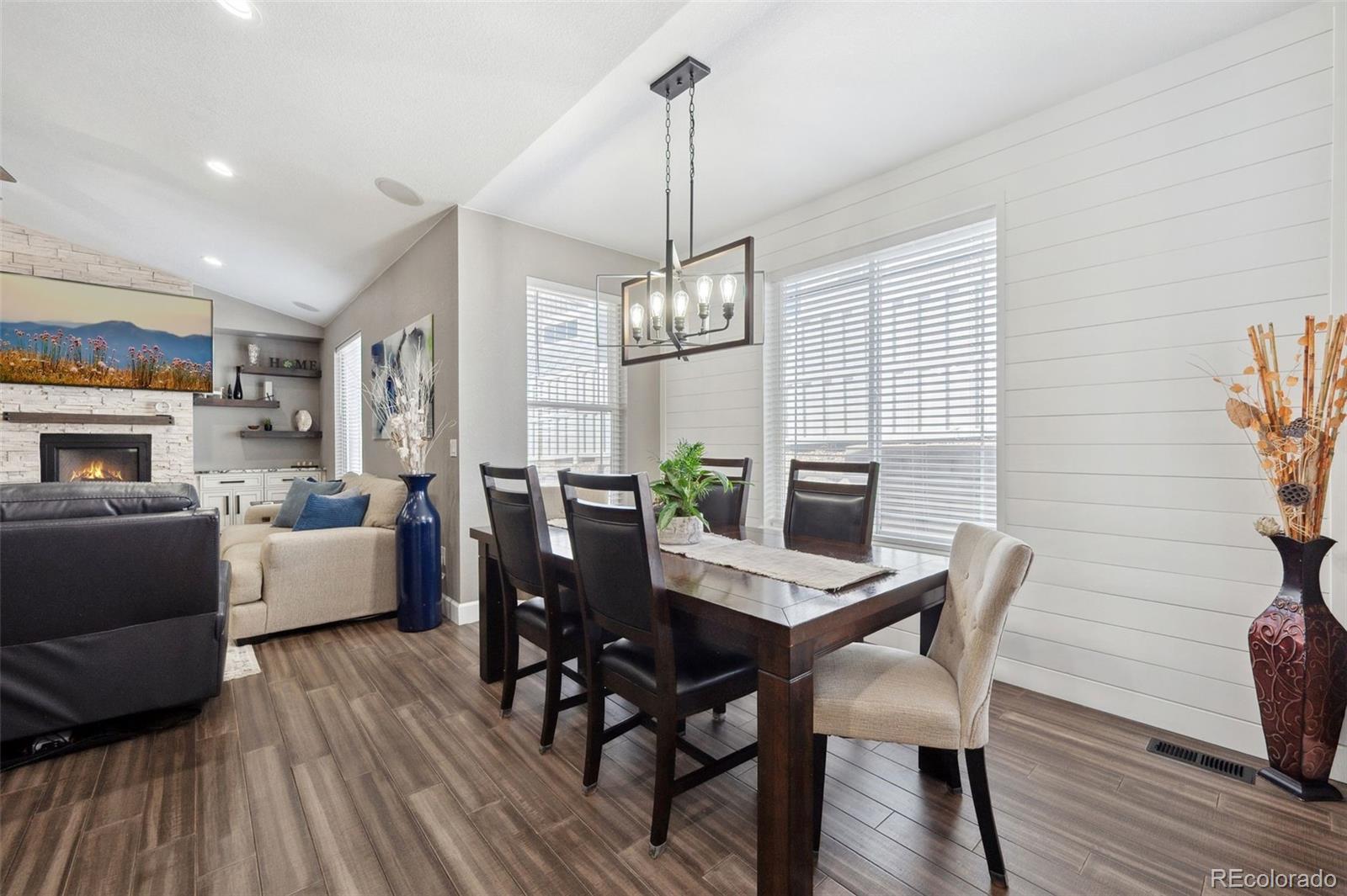 156 Chapel Hill Circle Brighton, CO 80601 - Photo 19 of 48 a view of a dining room with furniture window and wooden floor