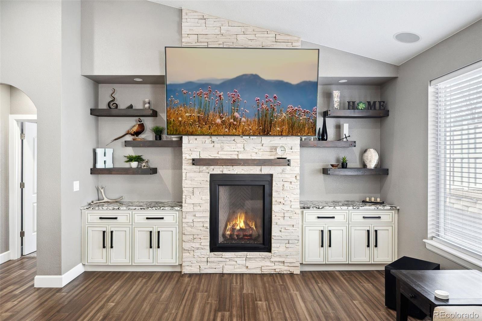 156 Chapel Hill Circle Brighton, CO 80601 - Photo 22 of 48 a living room with stainless steel appliances furniture a fireplace and a window