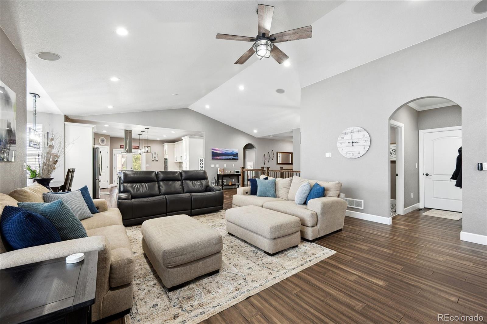 156 Chapel Hill Circle Brighton, CO 80601 - Photo 24 of 48 a living room with furniture and a wooden floor