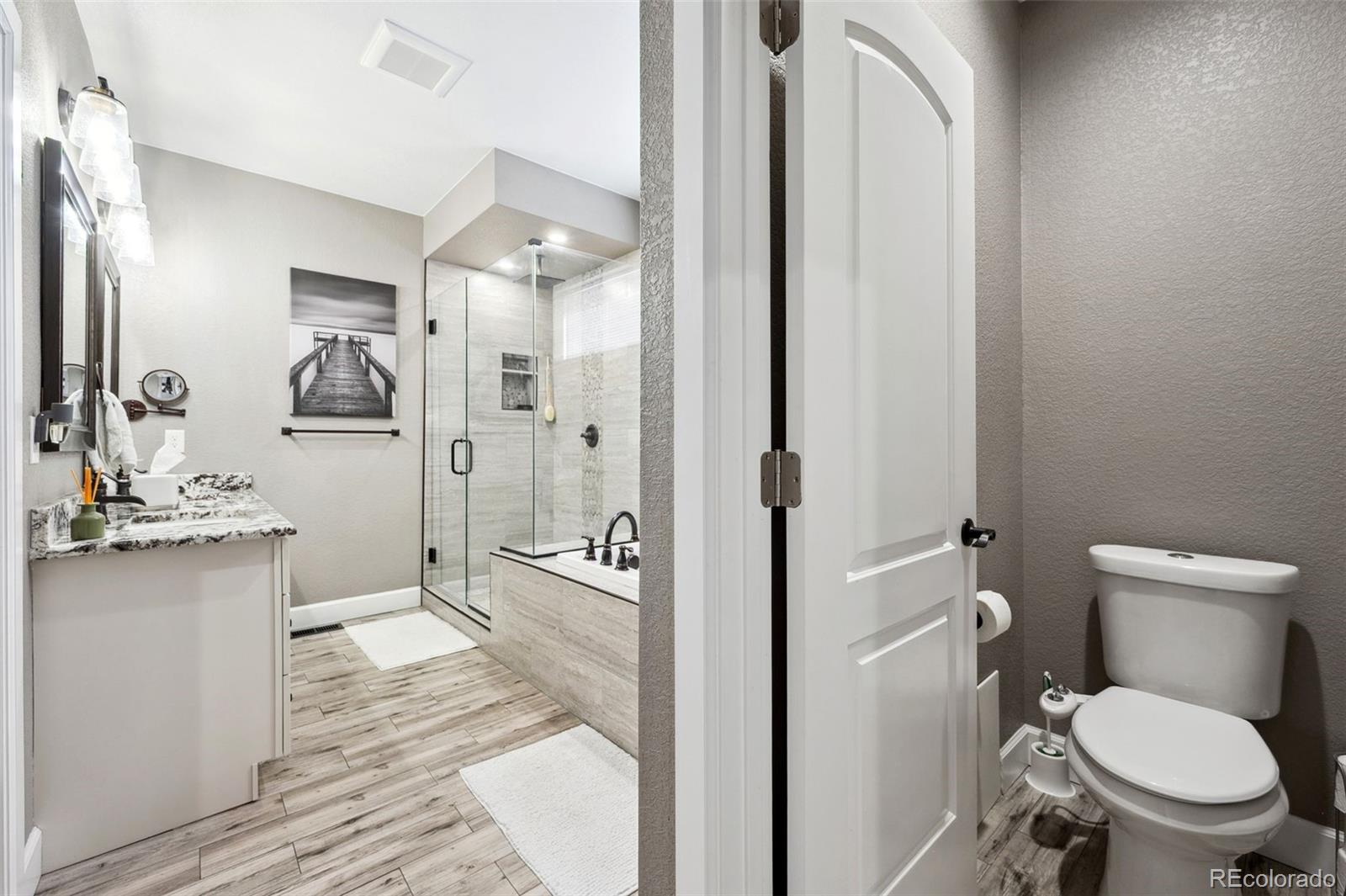 156 Chapel Hill Circle Brighton, CO 80601 - Photo 28 of 48 a bathroom with a granite countertop toilet sink and shower