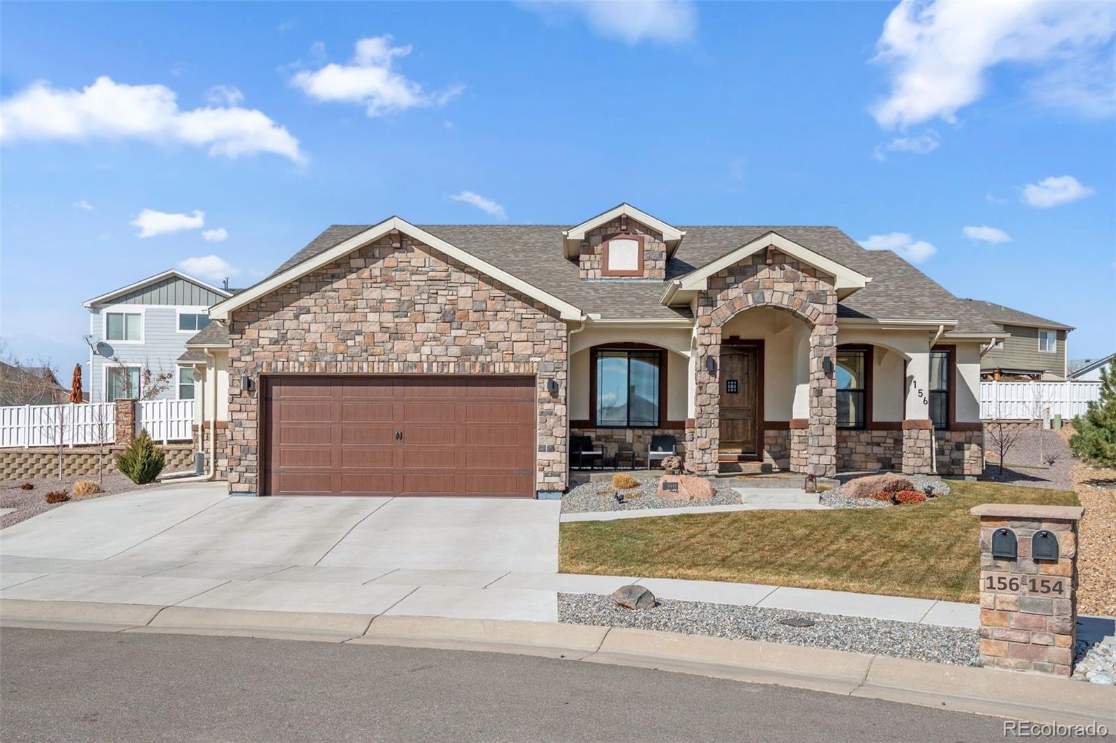 156 Chapel Hill Circle Brighton, CO 80601 - Photo 3 of 48 a front view of a house with garden