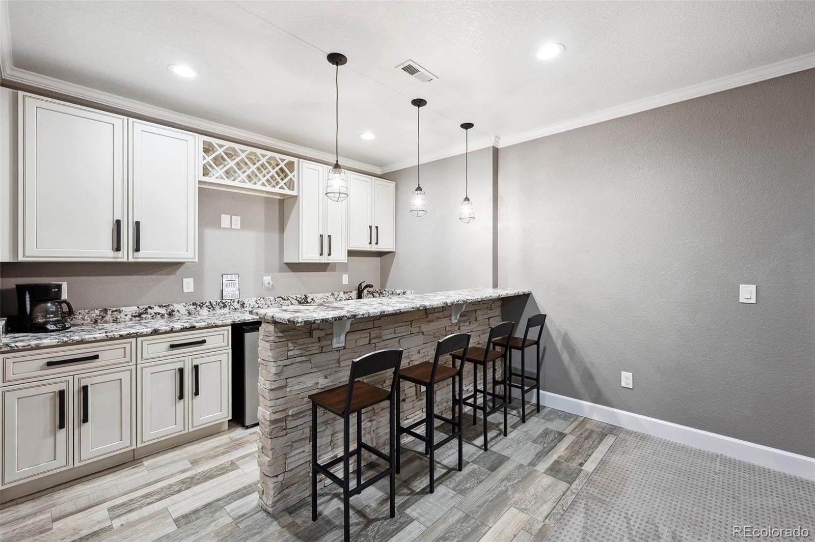 156 Chapel Hill Circle Brighton, CO 80601 - Photo 31 of 48 a kitchen with granite countertop a sink a center island a counter space and a window
