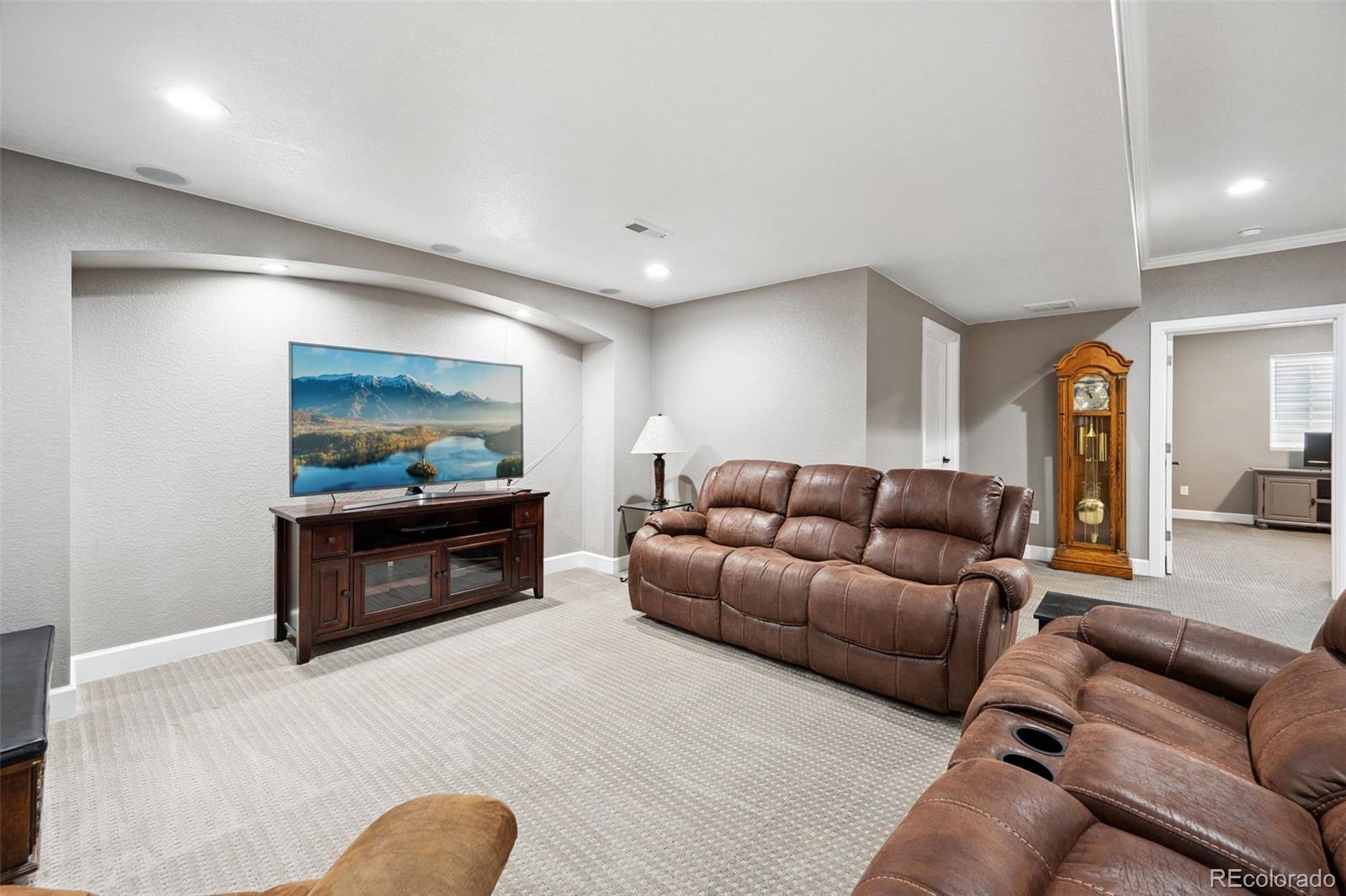 156 Chapel Hill Circle Brighton, CO 80601 - Photo 34 of 48 a living room with furniture and a flat screen tv