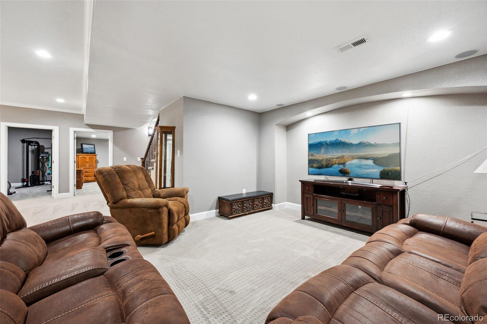 156 Chapel Hill Circle Brighton, CO 80601 - Photo 35 of 48 a living room with furniture and a flat screen tv