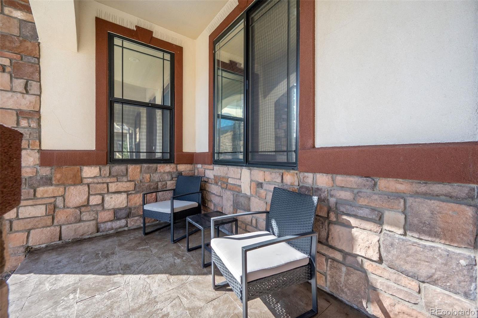 156 Chapel Hill Circle Brighton, CO 80601 - Photo 4 of 48 a couple of chairs sitting in front of a building