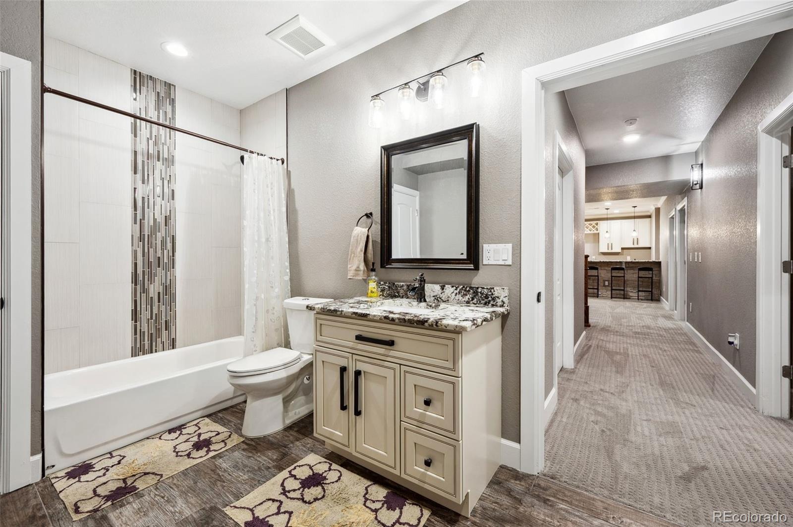 156 Chapel Hill Circle Brighton, CO 80601 - Photo 43 of 48 a spacious bathroom with a double vanity sink toilet mirror and bathtub