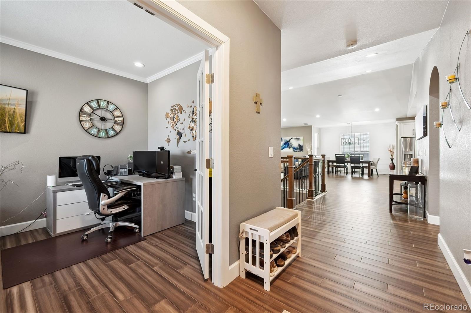 156 Chapel Hill Circle Brighton, CO 80601 - Photo 6 of 48 a view of a workspace with wooden floor