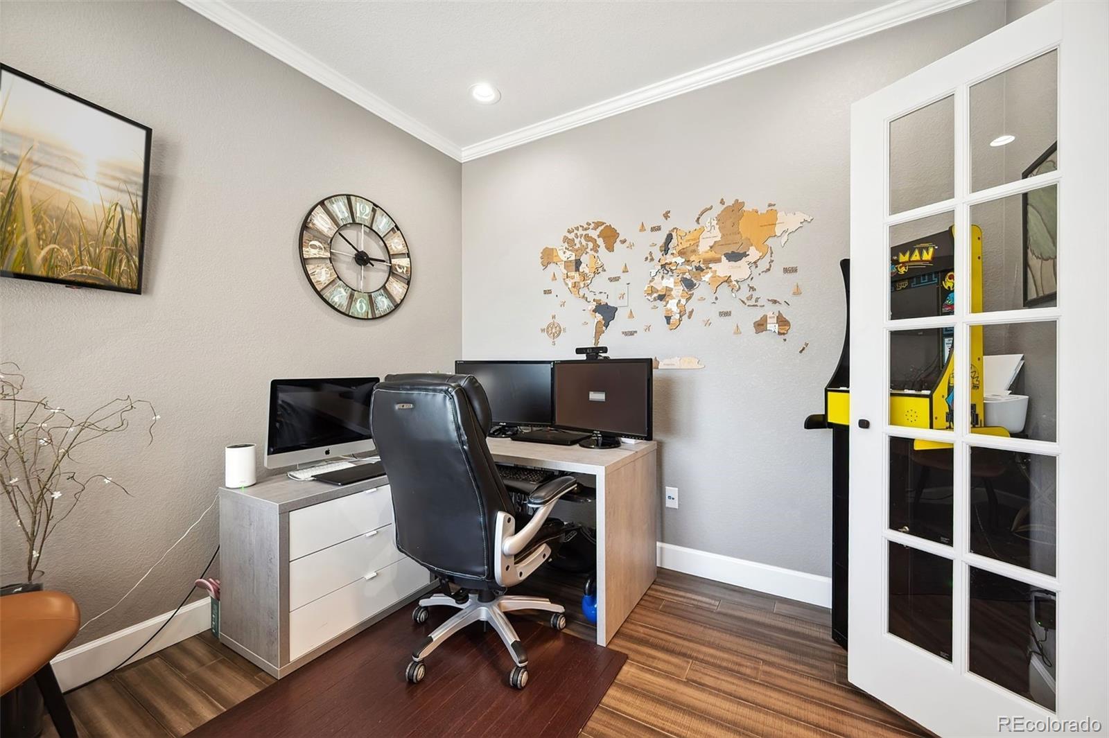 156 Chapel Hill Circle Brighton, CO 80601 - Photo 7 of 48 a view of a workspace with furniture and wooden floor