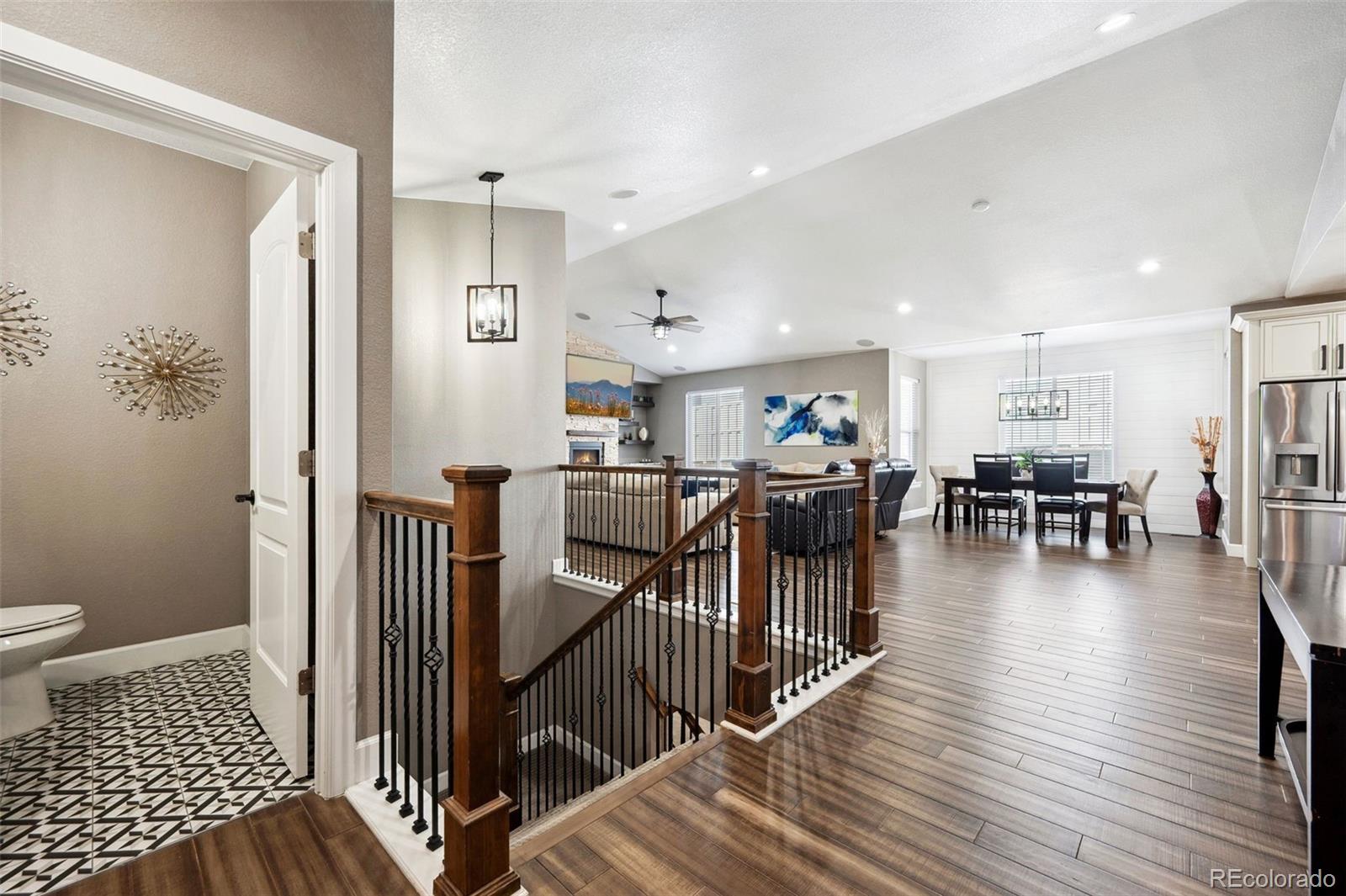 156 Chapel Hill Circle Brighton, CO 80601 - Photo 8 of 48 a view of a hallway with wooden floor and windows