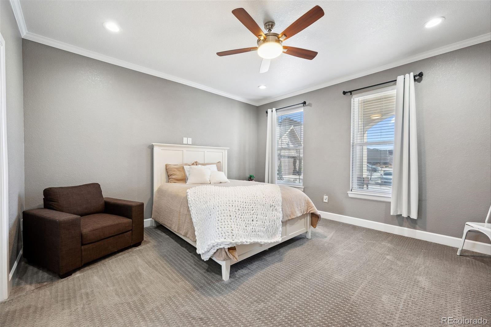 156 Chapel Hill Circle Brighton, CO 80601 - Photo 10 of 48 a spacious bedroom with a bed and couch