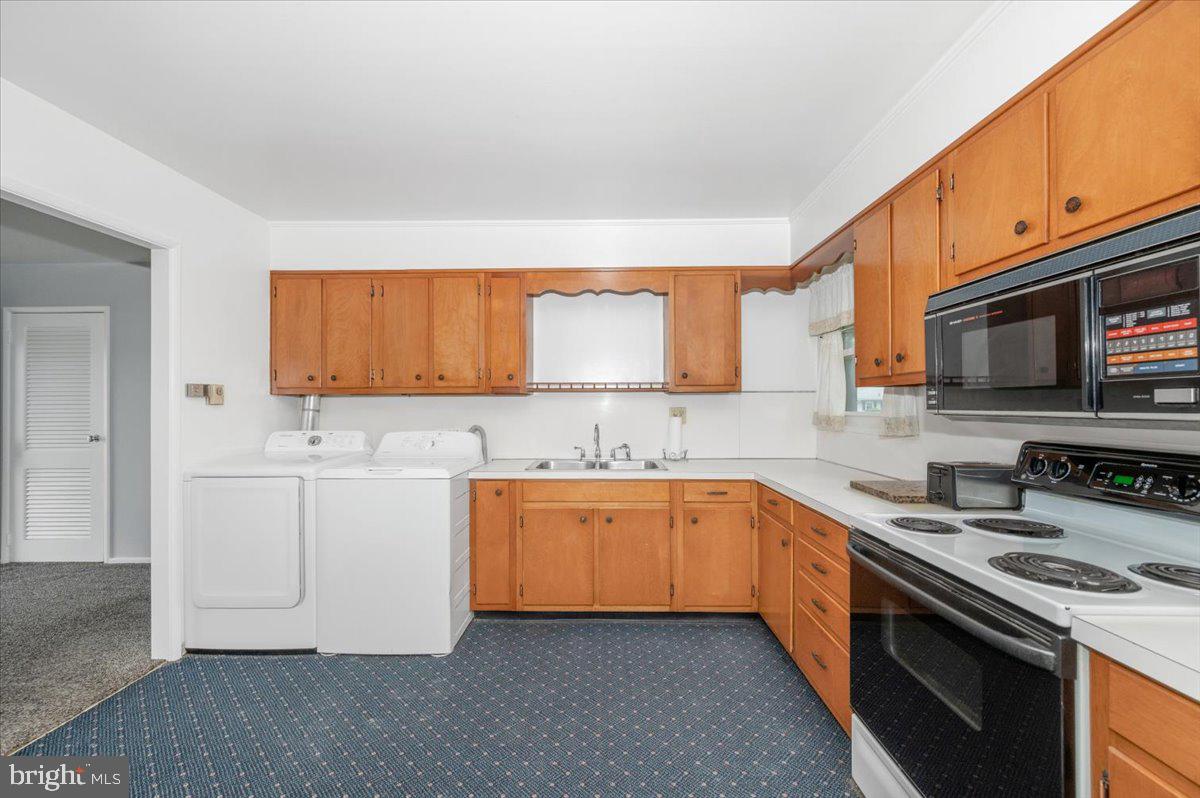 207 Barbara Street Frederick, MD 21701 - Photo 11 of 46 a kitchen with granite countertop a sink stove and cabinets