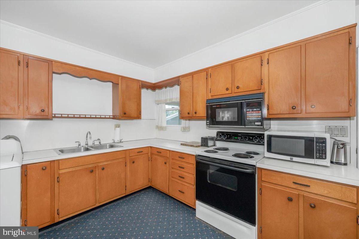 207 Barbara Street Frederick, MD 21701 - Photo 12 of 46 a kitchen with stainless steel appliances granite countertop a sink stove and microwave