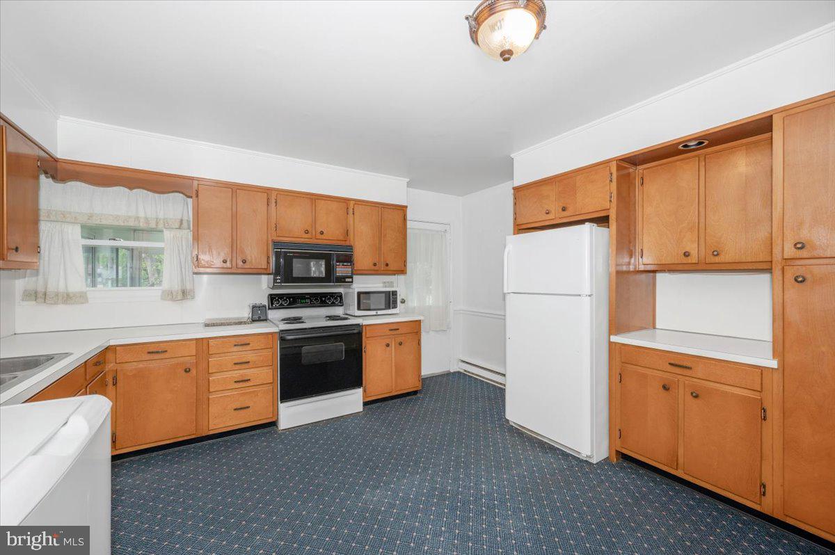 207 Barbara Street Frederick, MD 21701 - Photo 13 of 46 a kitchen with stainless steel appliances granite countertop a refrigerator a stove top oven a sink dishwasher and white cabinets with wooden floor