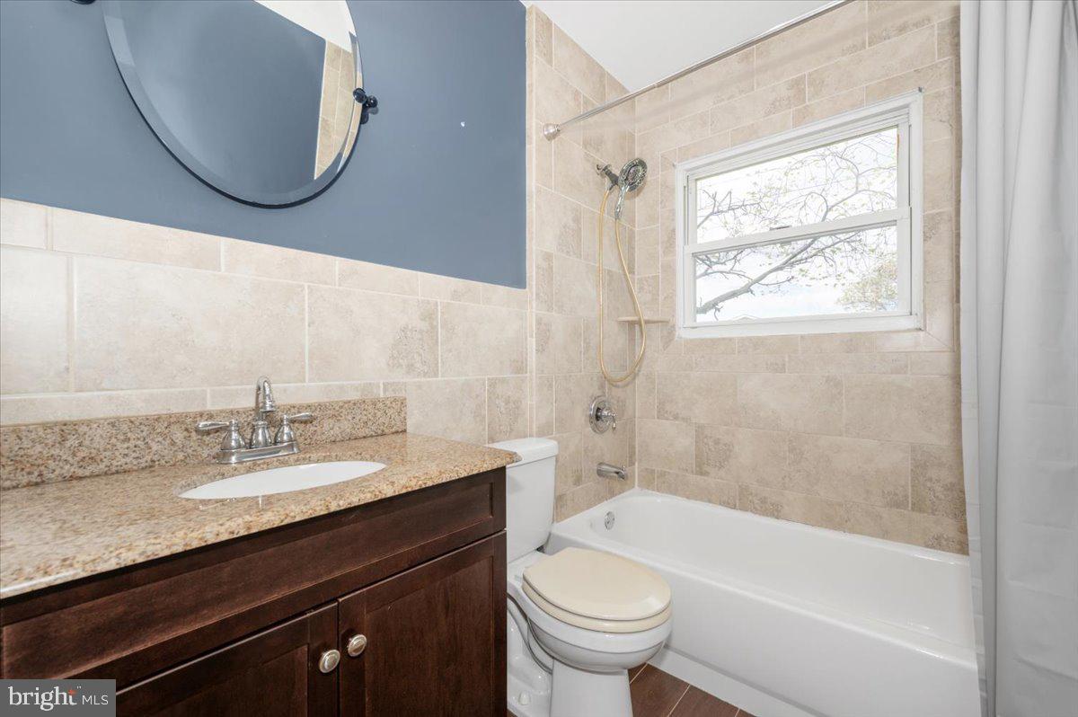 207 Barbara Street Frederick, MD 21701 - Photo 32 of 46 a bathroom with a granite countertop sink a toilet and bathtub