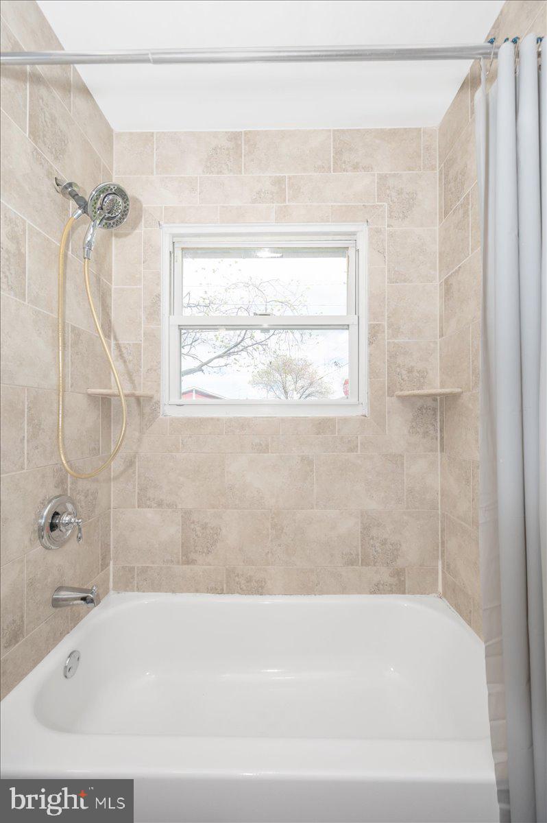 207 Barbara Street Frederick, MD 21701 - Photo 33 of 46 a bathroom with a bathtub and a shower