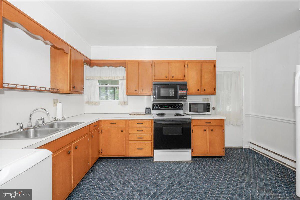 207 Barbara Street Frederick, MD 21701 - Photo 10 of 46 a kitchen with stainless steel appliances a sink stove and microwave