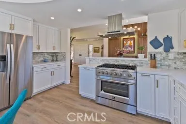 a kitchen with stainless steel appliances granite countertop a stove a refrigerator and a sink
