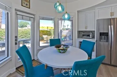 a view of a dining room with furniture a chandelier and wooden floor