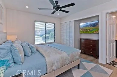 a bedroom with a bed and a mirror on the dresser