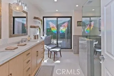 a bathroom with a sink a mirror and a shower
