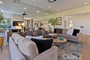 a living room with furniture a large window and a fireplace
