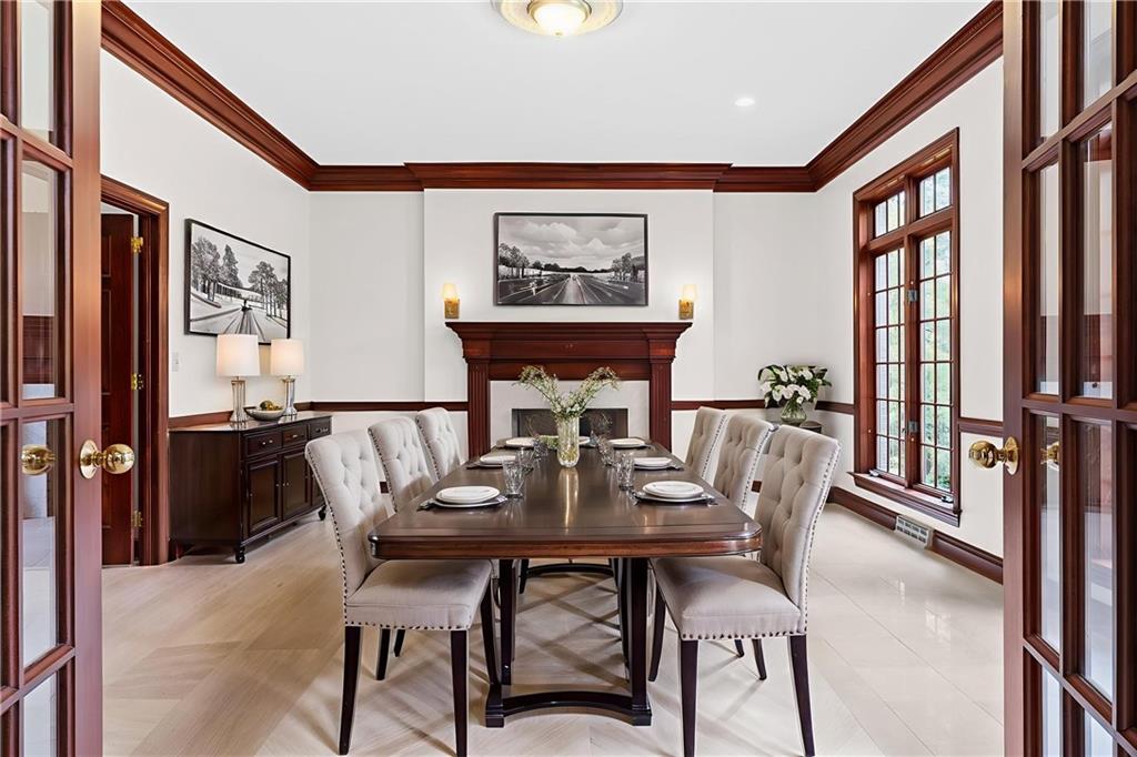 1060 Fox Chapel Road Pittsburgh, PA 15238 - Photo 13 of 50 Formal dining room with marble flooring and gas fireplace, located just off the kitchen for easy entertaining