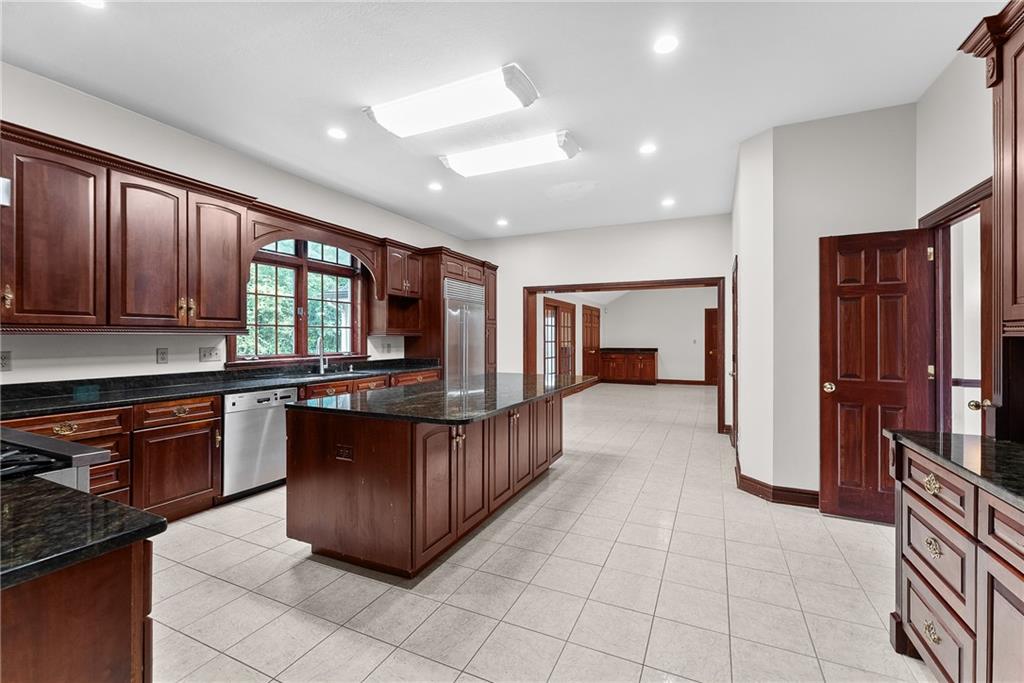 1060 Fox Chapel Road Pittsburgh, PA 15238 - Photo 18 of 50 Expansive kitchen with marble flooring, solid cherry cabinetry, granite countertops, and a large center island—designed for gathering, cooking, and everyday living