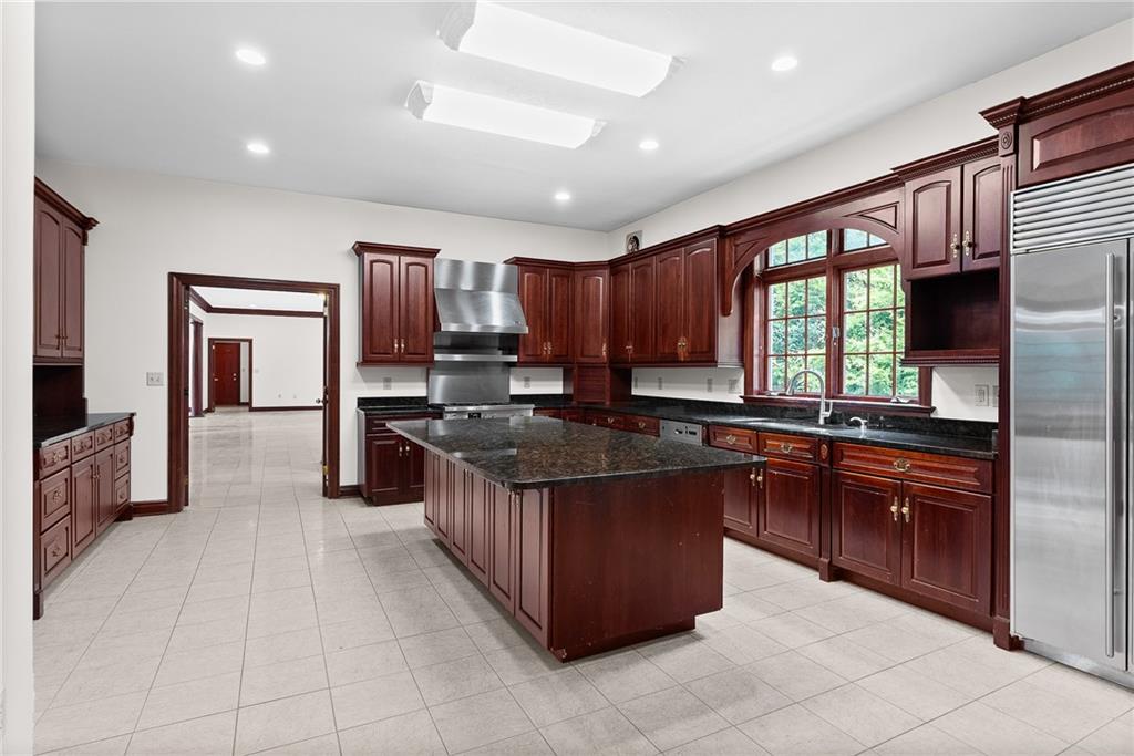 1060 Fox Chapel Road Pittsburgh, PA 15238 - Photo 19 of 50 Expansive kitchen with marble flooring, solid cherry cabinetry, granite countertops, and a large center island—designed for gathering, cooking, and everyday living