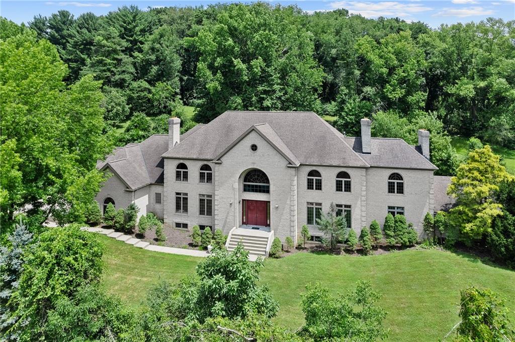 1060 Fox Chapel Road Pittsburgh, PA 15238 - Photo 2 of 50 All-brick estate custom built in 2000 by Madia Homes, situated on 3.3 acres in a highly coveted Fox Chapel location. Property includes two residences—the primary home and the original 1950s ranch—offering exceptional space and future possibilities