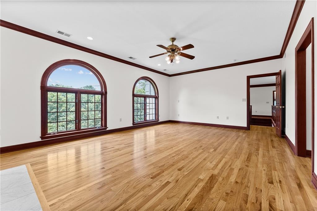 1060 Fox Chapel Road Pittsburgh, PA 15238 - Photo 28 of 50 Spacious primary suite occupying its own wing of the home, featuring a marble surround gas fireplace, two walk-in closets, private den, and ensuite bath with jetted tub, steam shower, and dual vanities with granite countertops