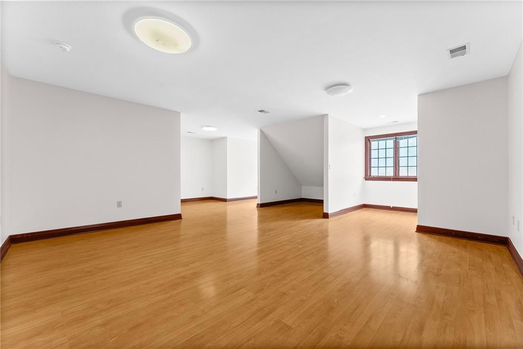 1060 Fox Chapel Road Pittsburgh, PA 15238 - Photo 39 of 50 Spacious fifth bedroom above the garage—ideal for a playroom, media room, study, or flex space—with convenient staircase access to the first-floor laundry room