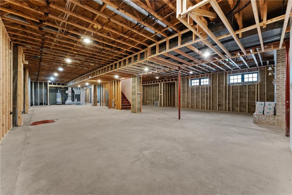 1060 Fox Chapel Road Pittsburgh, PA 15238 - Photo 41 of 50 Unfinished 2,322 sq ft basement already framed with heating, cooling, and electrical in place. Features 9' ceilings, fireplace, partially finished full bath, and multiple staircases for access to upper levels. Exceptional potential for future living space including game room, media room, or golf simulator