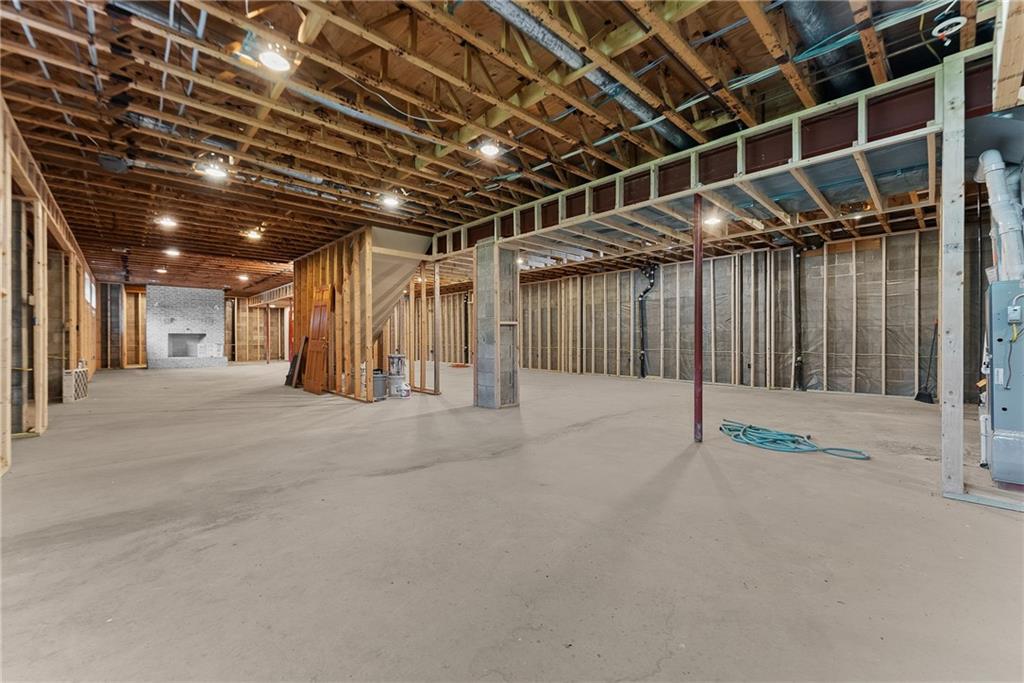 1060 Fox Chapel Road Pittsburgh, PA 15238 - Photo 42 of 50 Unfinished 2,322 sq ft basement already framed with heating, cooling, and electrical in place. Features 9' ceilings, fireplace, partially finished full bath, and multiple staircases for access to upper levels. Exceptional potential for future living space including game room, media room, or golf simulator