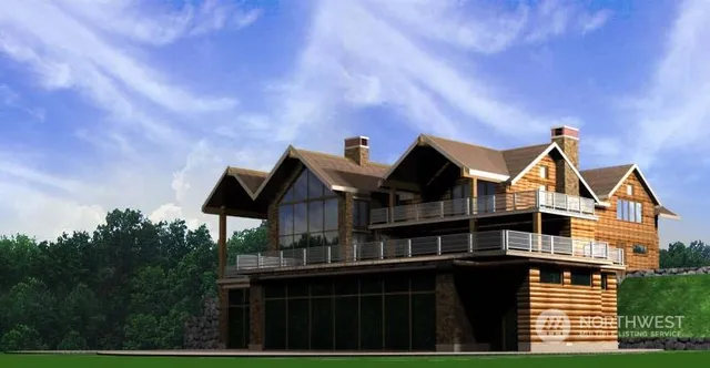 a view of house with backyard and trees in the background