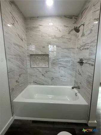 a spacious bathroom with a double vanity sink and a toilet