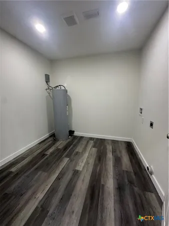 a kitchen with sink cabinets and wooden floor