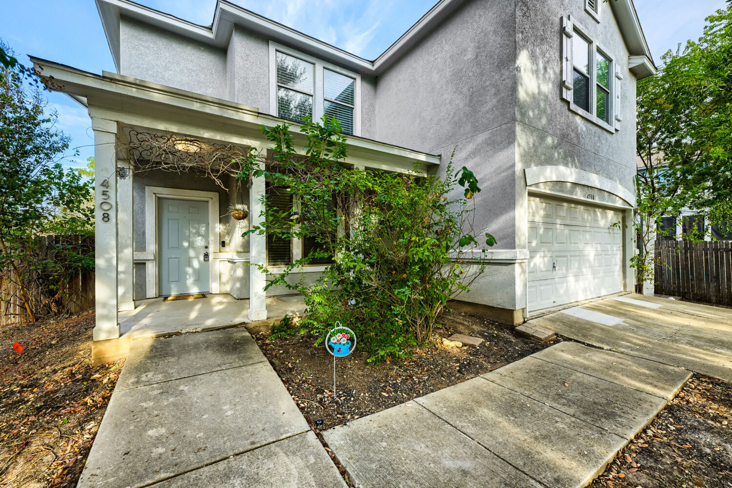 4508 Peach Grove Road Austin, TX 78744 - Photo 20 of 22 Concrete walkways lead past a covered front porch to the entry and attached garage.