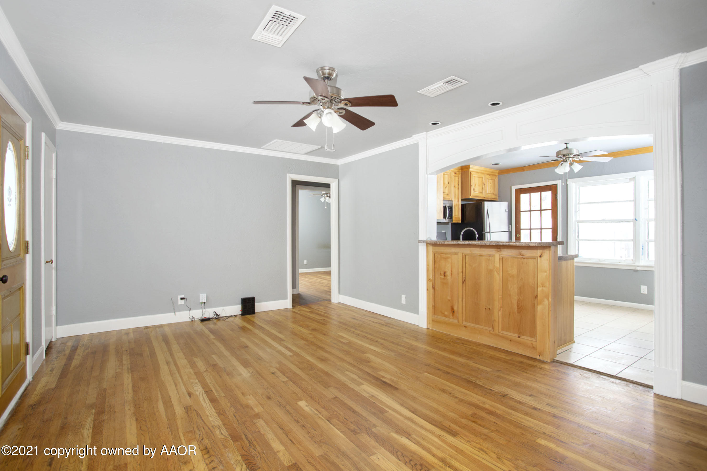4312 South Monroe Street Amarillo, TX 79110 - Photo 2 of 18 a view of empty room with wooden floor and fan