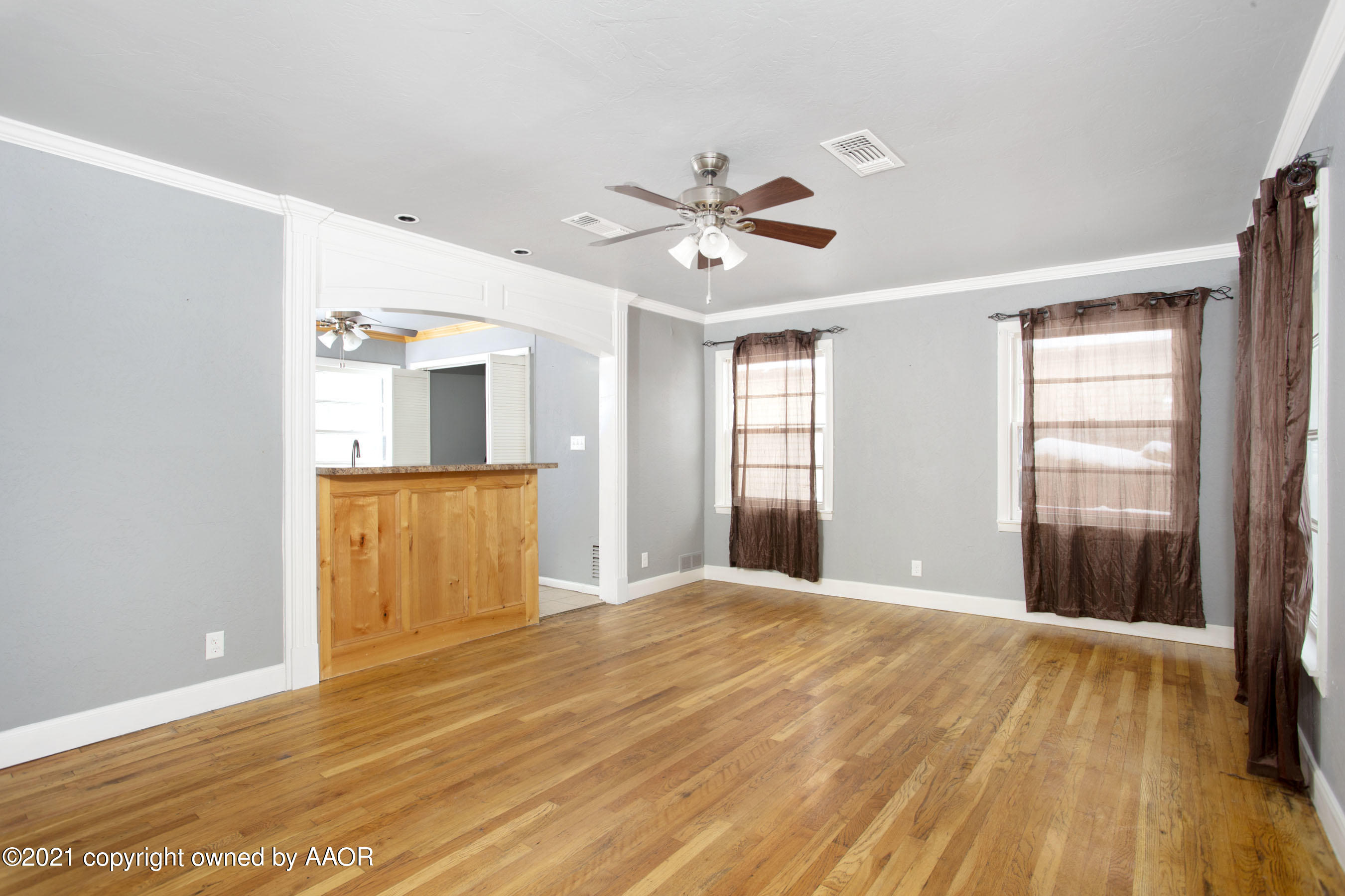 4312 South Monroe Street Amarillo, TX 79110 - Photo 4 of 18 a view of empty room with wooden floor and fan