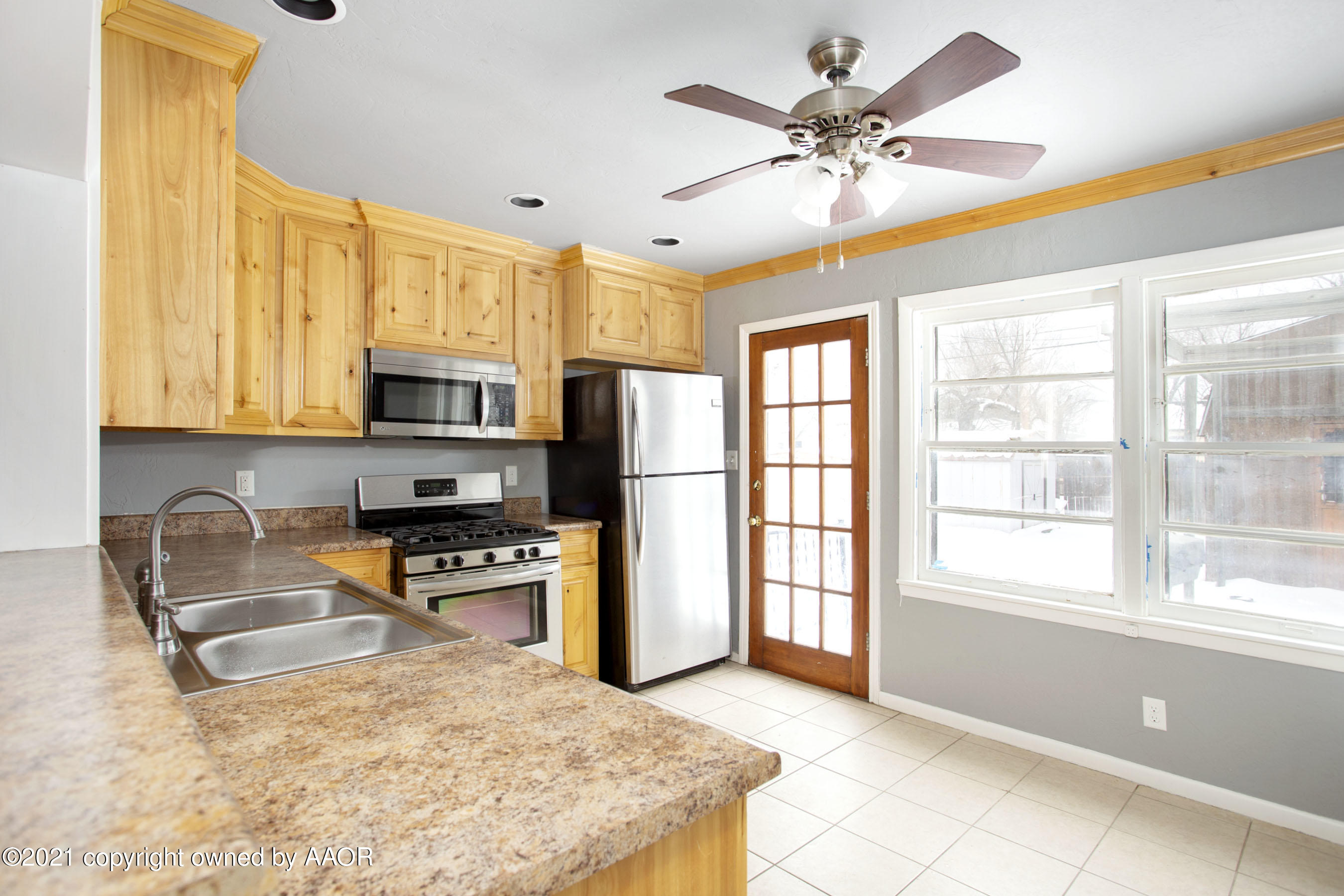 4312 South Monroe Street Amarillo, TX 79110 - Photo 5 of 18 a kitchen with stainless steel appliances granite countertop a stove and a refrigerator