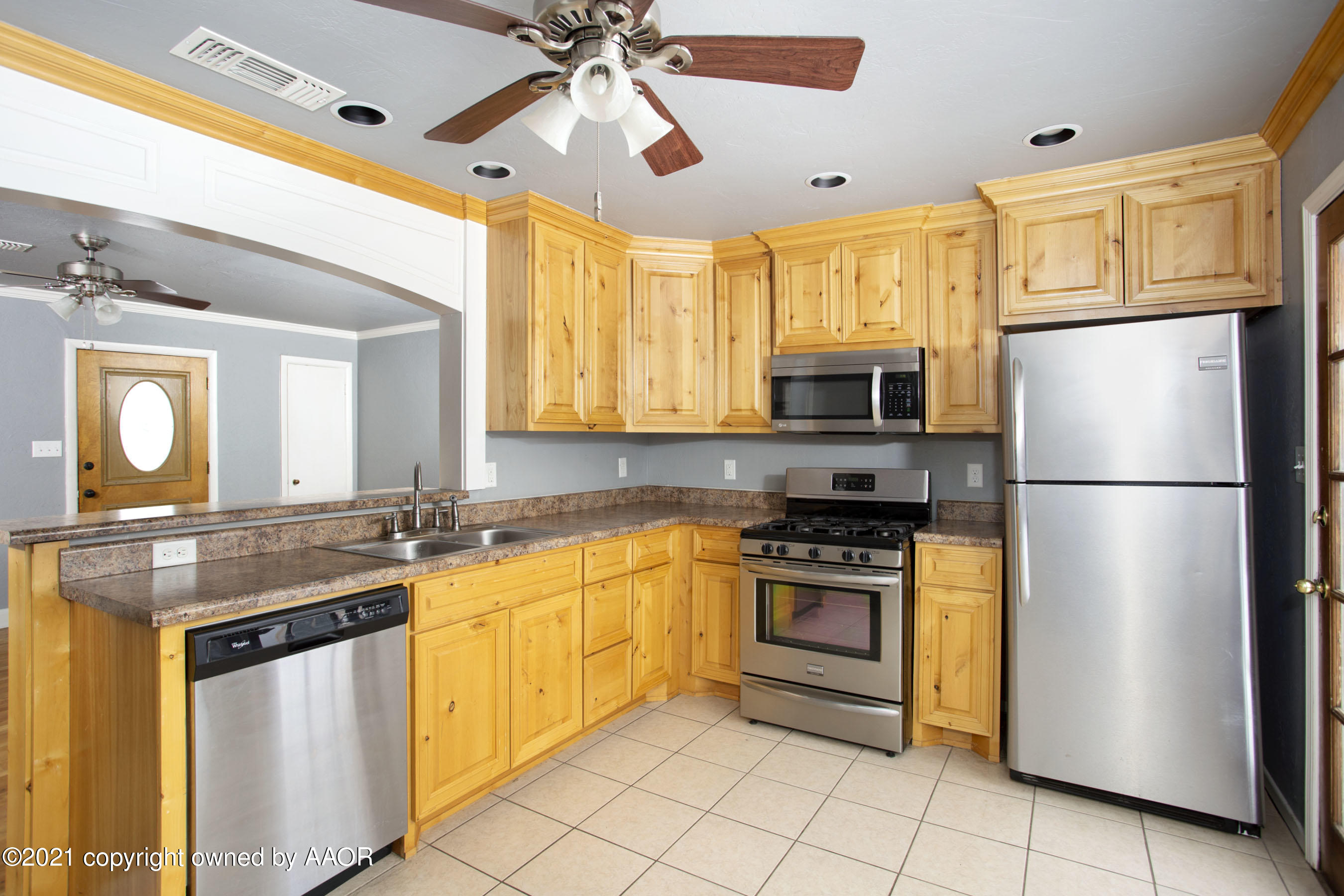4312 South Monroe Street Amarillo, TX 79110 - Photo 6 of 18 a kitchen with granite countertop a sink stainless steel appliances and cabinets