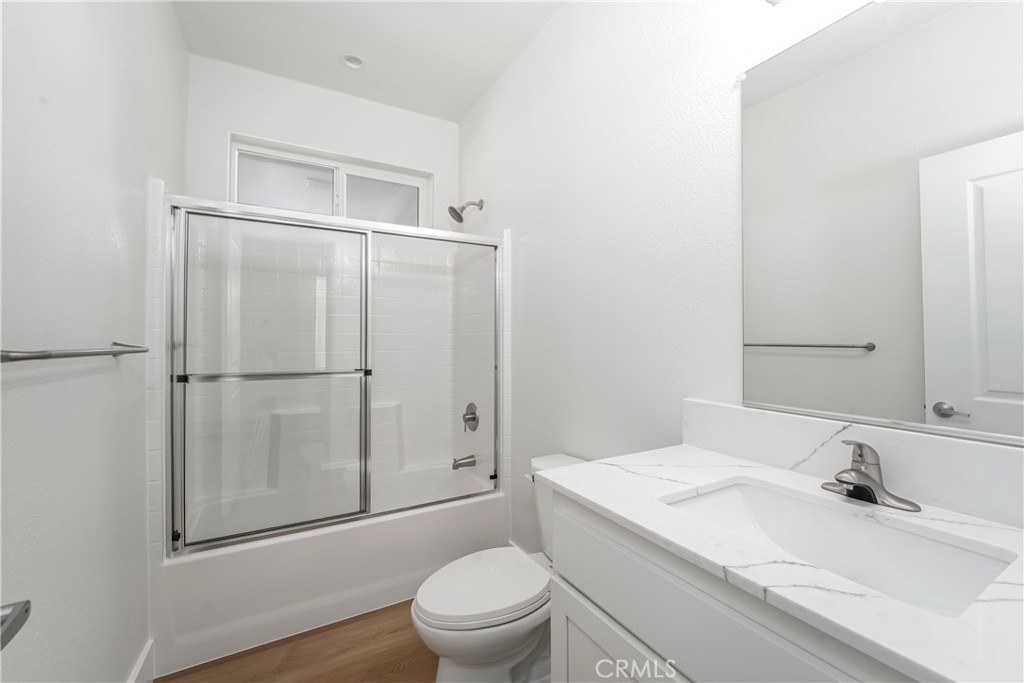 1120 East Mission Road, Unit 57 Fallbrook, CA 92028 - Photo 11 of 25 a bathroom with a granite countertop sink toilet and shower