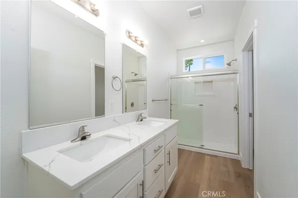 a bathroom with a sink a mirror and a shower